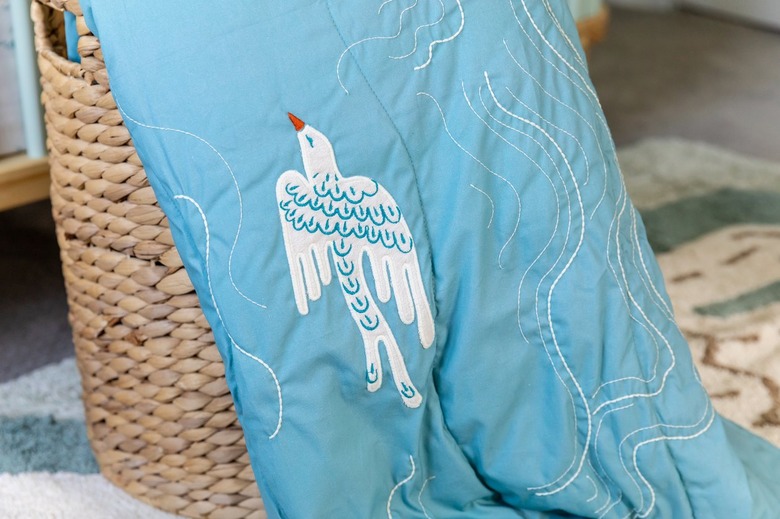 A bright blue quilt with white