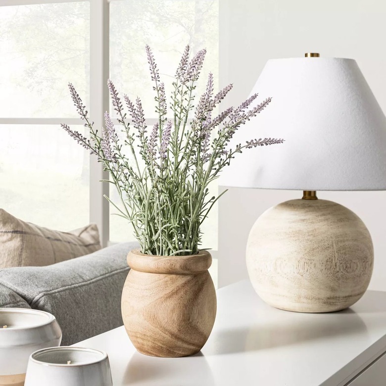 faux lavender in pot on table next to lamp