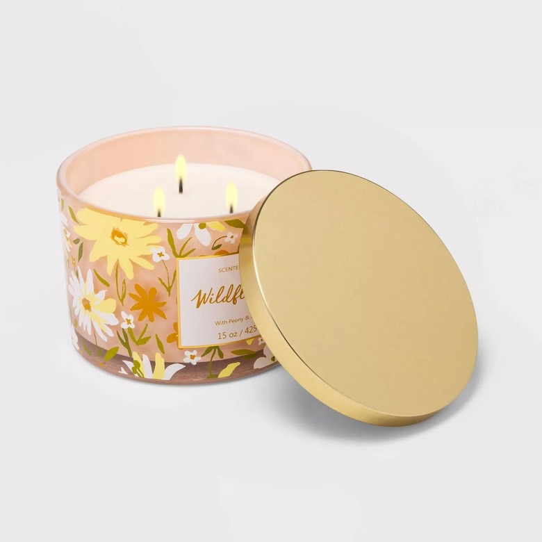 lidded candle with three wicks and floral design