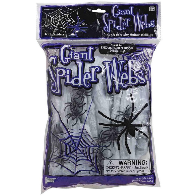 A clear package of white spiderwebs with small black fake spiders in it. The package says Giant Spider Webs in a purple and white font.