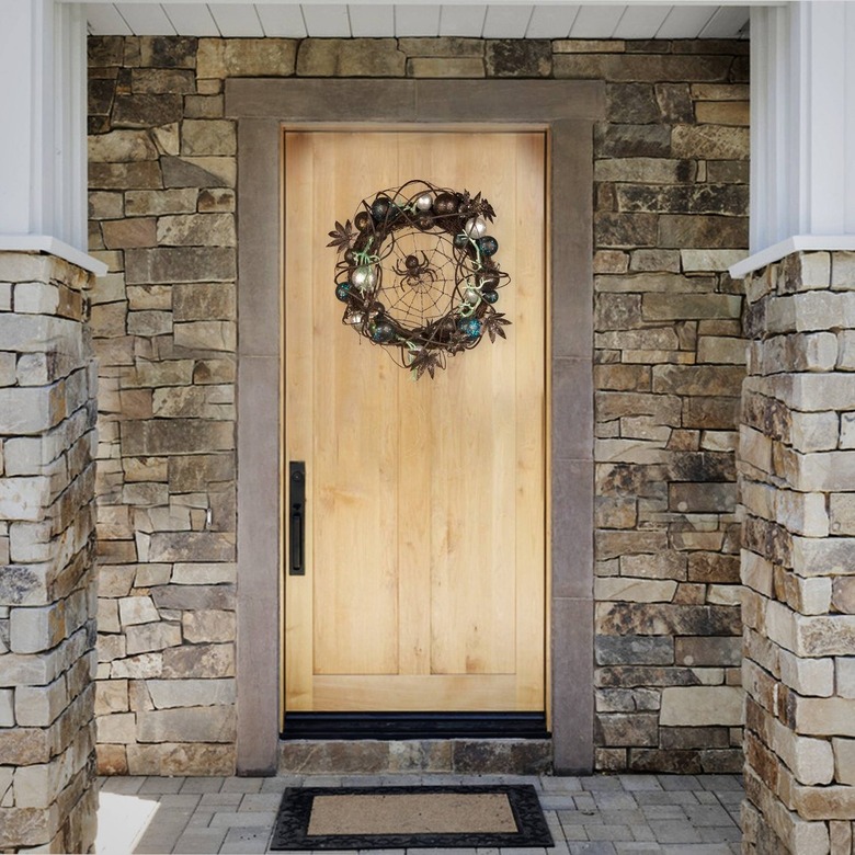 A light wood door surrounded by gray brick. In the top-center of the door