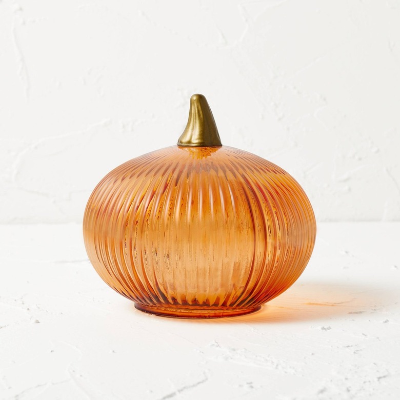 An orange glass pumpkin with a gold stem.