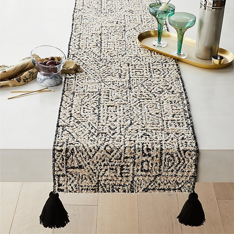 cream and black pattern table runner with tassels