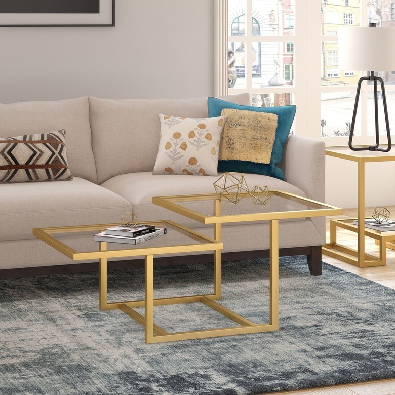 Brass coffee table with two square levels and glass tops