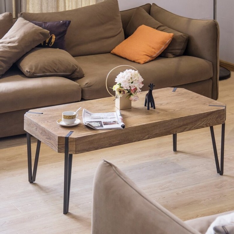 Rounded rectangular wood coffee table with black metal legs