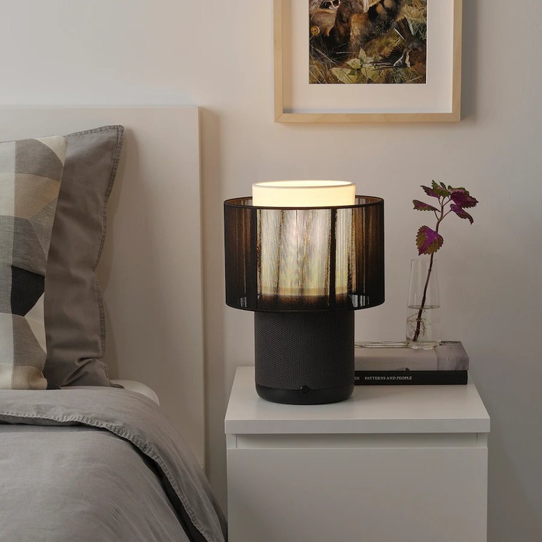 bed and nightstand with black lamp