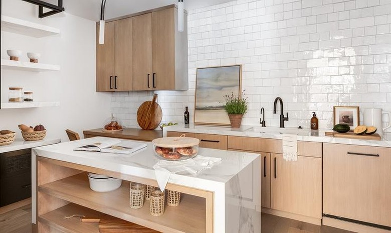 white and tan kitchen with bronze fixtures