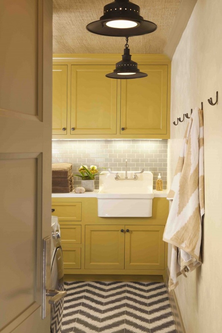 laundry room with yellow cabinets