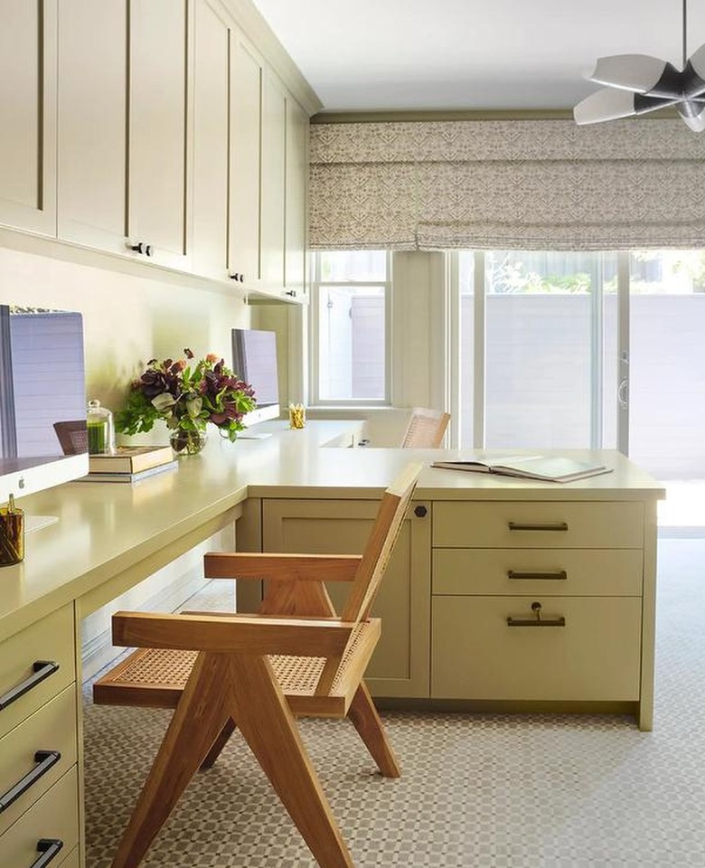 home office with light olive desk drawers and bronze fixtures