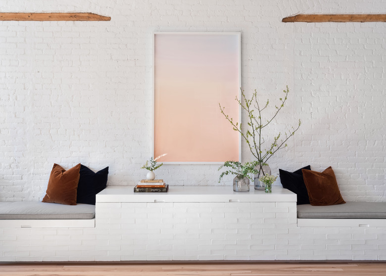 living room with built in bench seating and brick walls