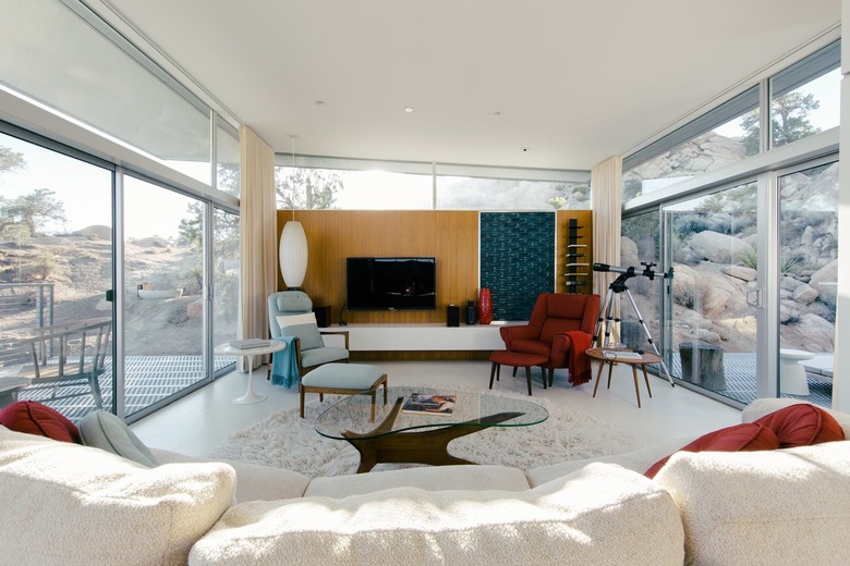 a light-flooded living room full of mid-century furniture
