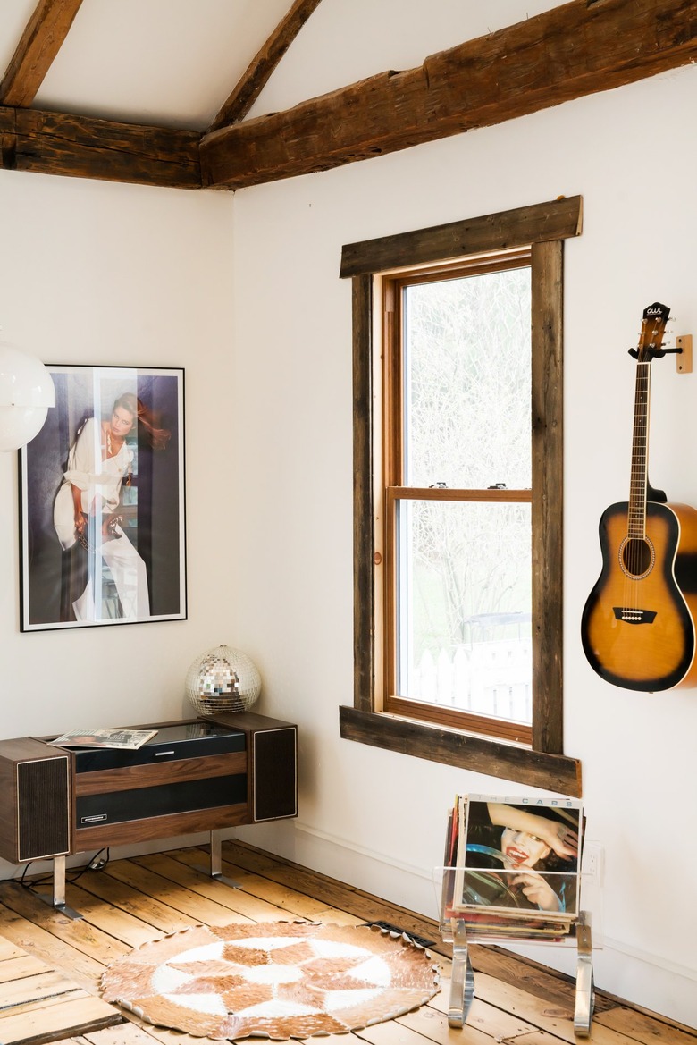a half-timbered room with a guitar on the wall