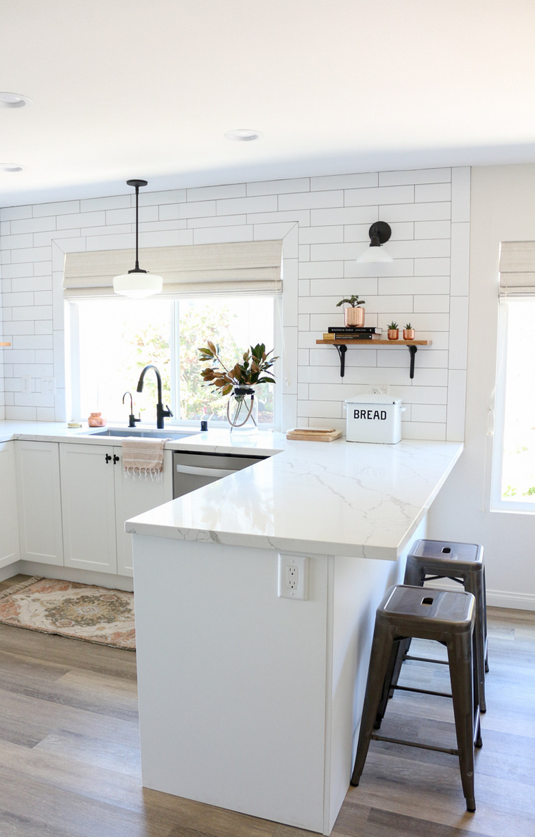Farmhouse kitchen lighting with pendant light over sink in all-white kitchen