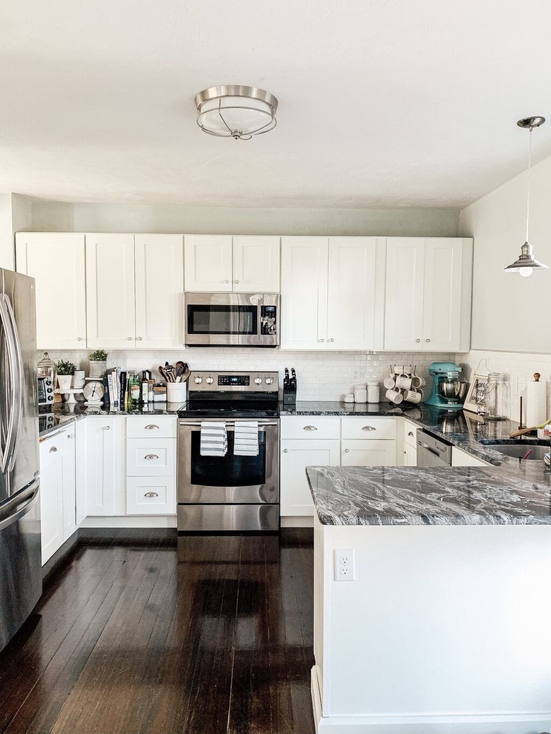 farmhouse kitchen with white cabinets and stainless steel appliances