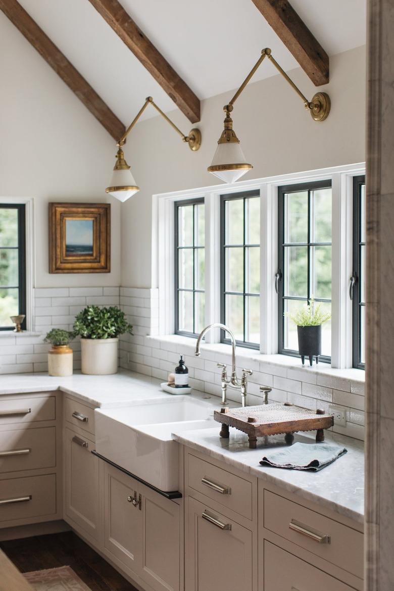 farmhouse kitchen with brass and white articulated wall sconces