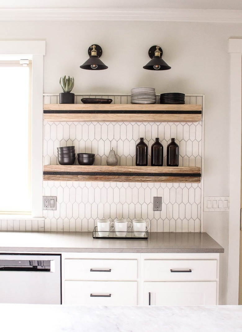 black and wood floating shelves with black wall sconces