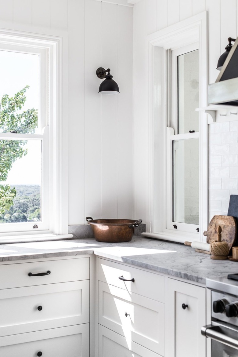 white farmhouse kitchen with black wall sconces