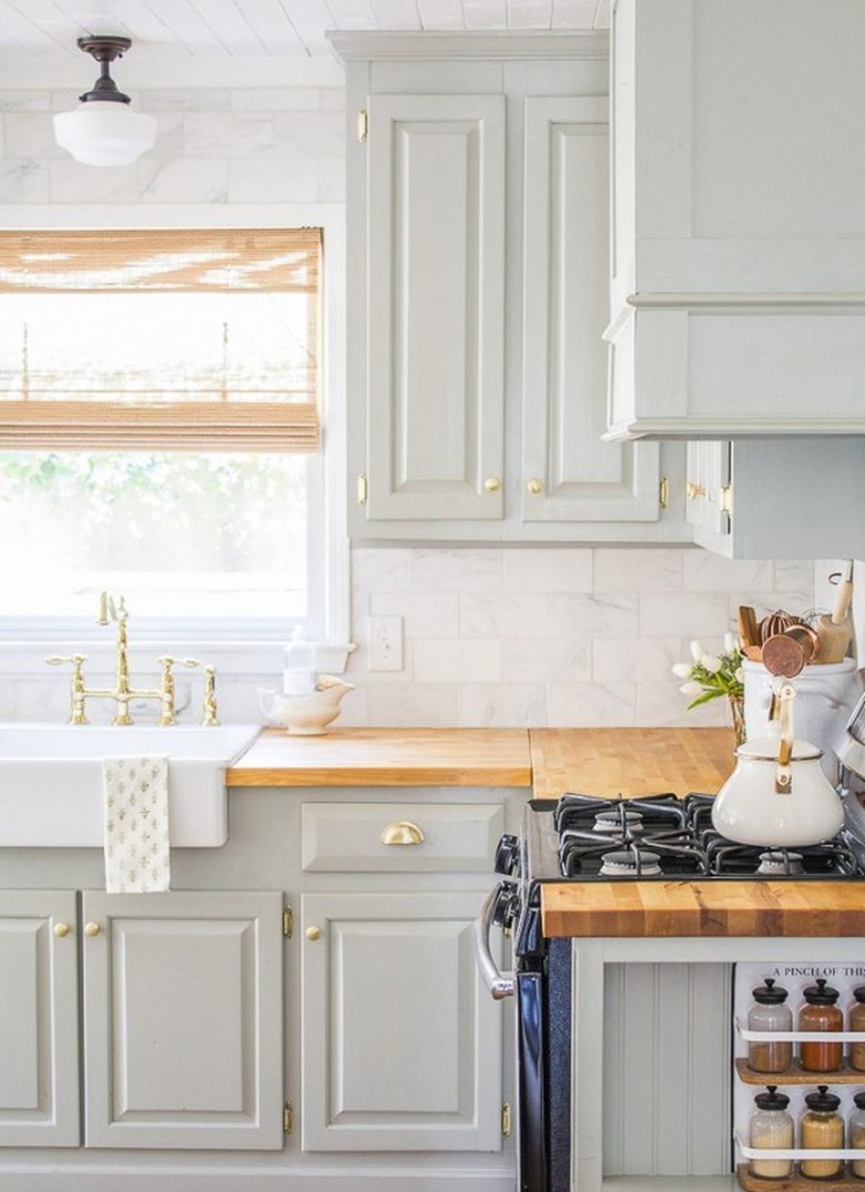 white and light green farmhouse kitchen with milk glass ceiling light