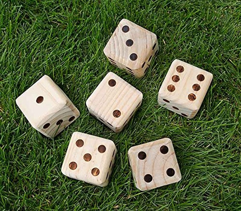 Large wooden dice in grass