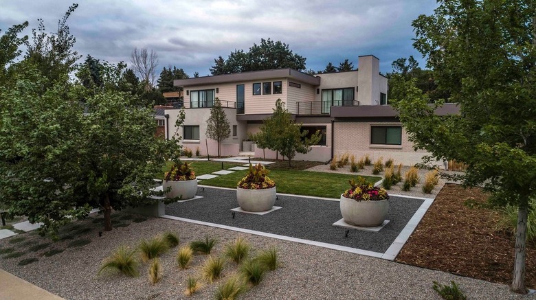 An aerial view of gravel patios with three large stone planters and a variety of plants