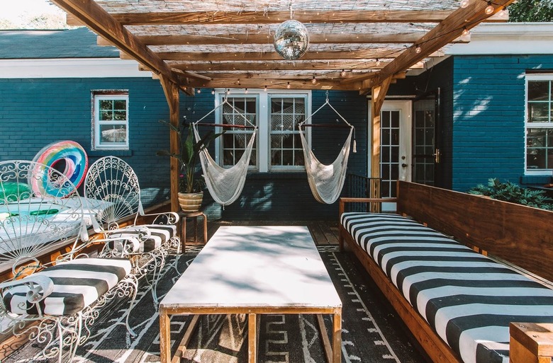A whimsical backyard patio features a covered pergola