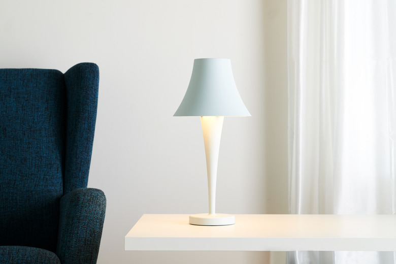 table lamp near sofa chair