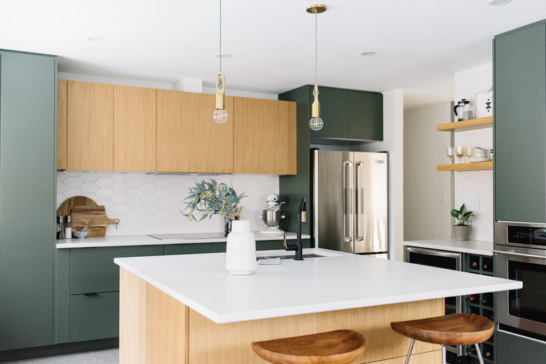 green kitchen cabinets and wood cabinets with marble countertop and backsplash