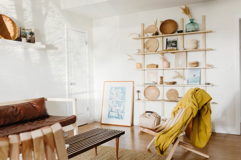 Boho living room with leather couch and wooden reclining chairs
