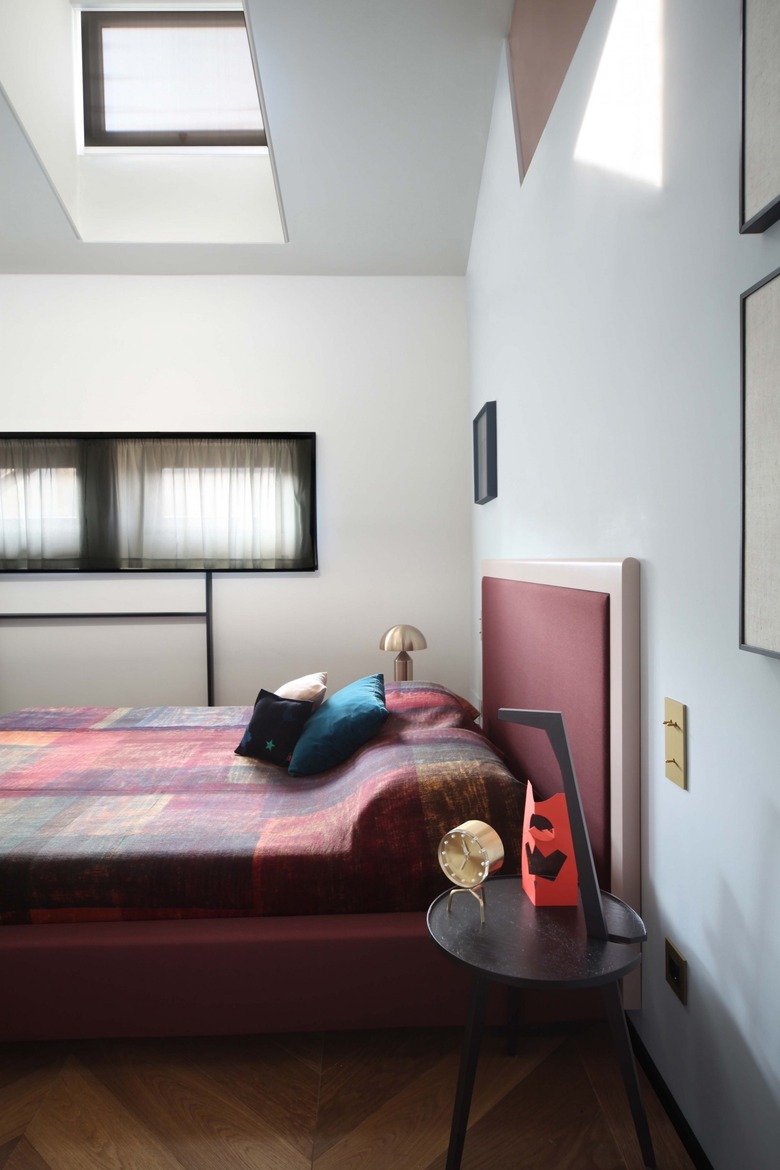 bedroom with angled roof and skylight