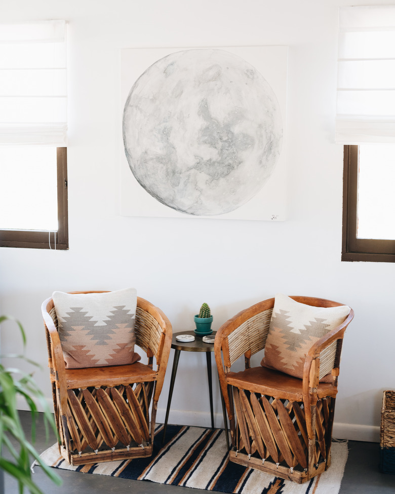 rustic equipale chairs in living room near windows