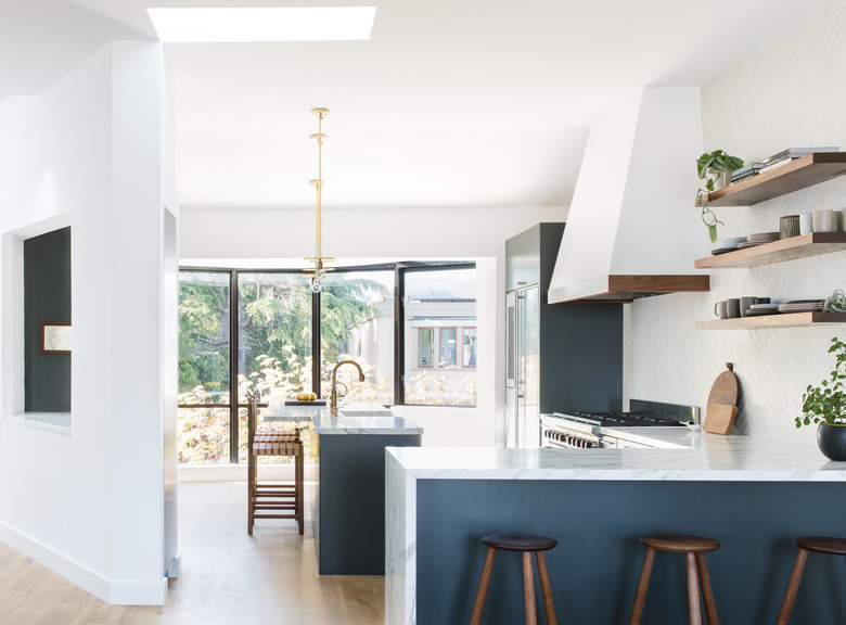white kitchen with marble and navy accents