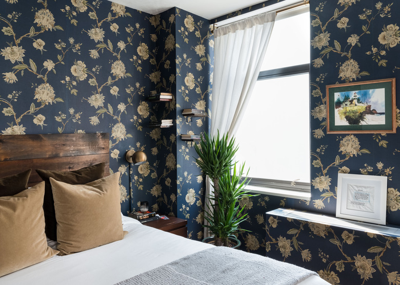 bedroom with navy floral wallpaper