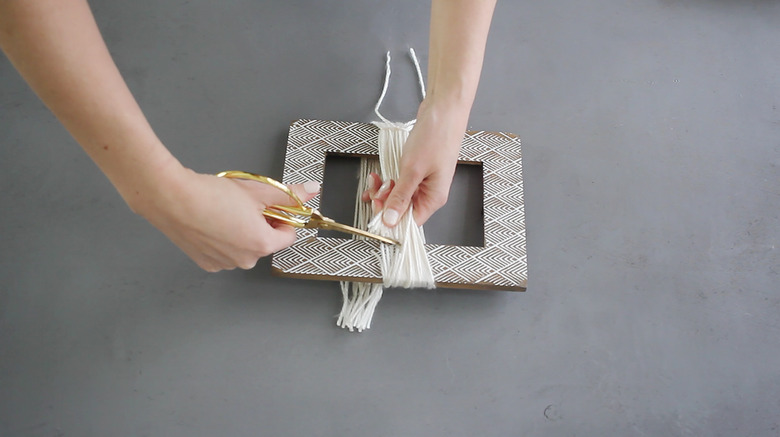 Cutting yarn off the picture frame
