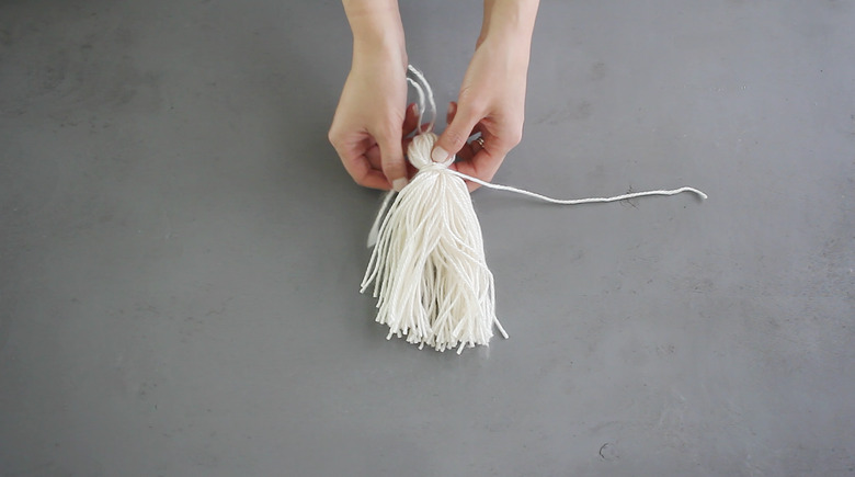 Wrapping one of the tails around the tassel