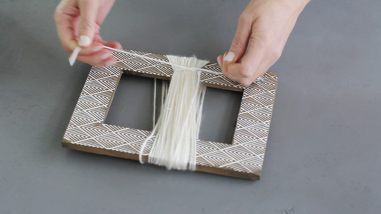 Tying a knot around the wrapped yarn