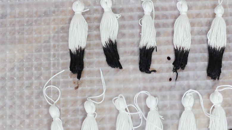 Dip-dyed tassels laying flat to dry