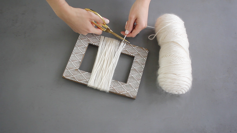 Yarn wrapped around empty picture frame
