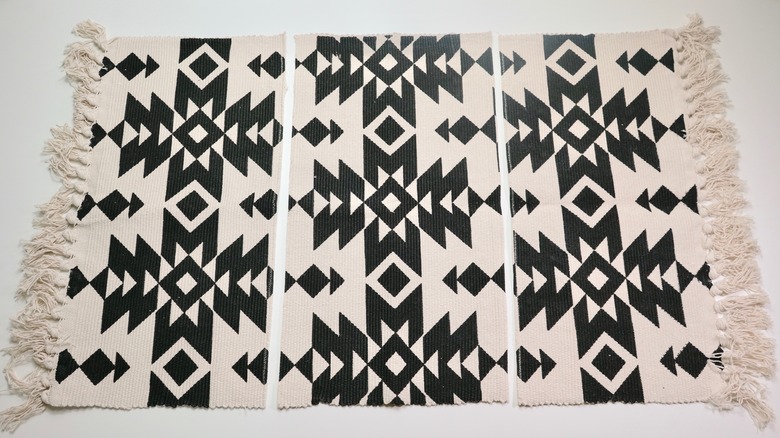 Cutting excess material from fringe rug for DIY Fringe Pillow project.