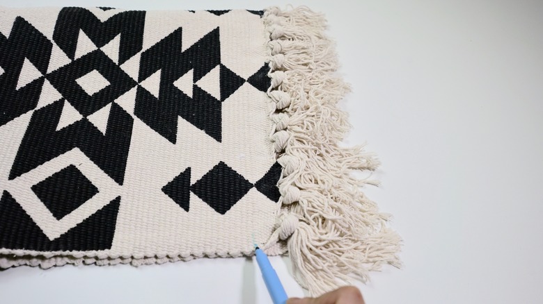 Preparing to stitch diagonal seams for DIY Fringe Pillow project.