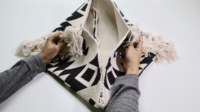 Preparing to stitch diagonal seams for DIY Fringe Pillow project.