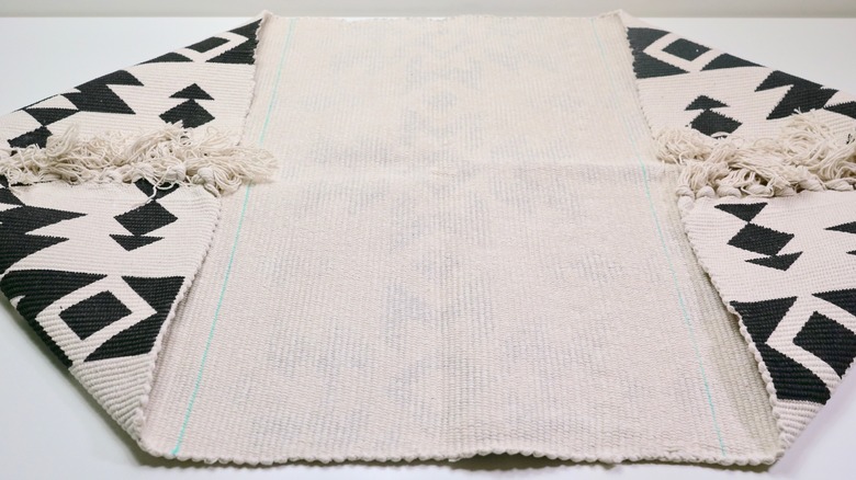 Lines marked on a rug for DIY Fringe Pillow project