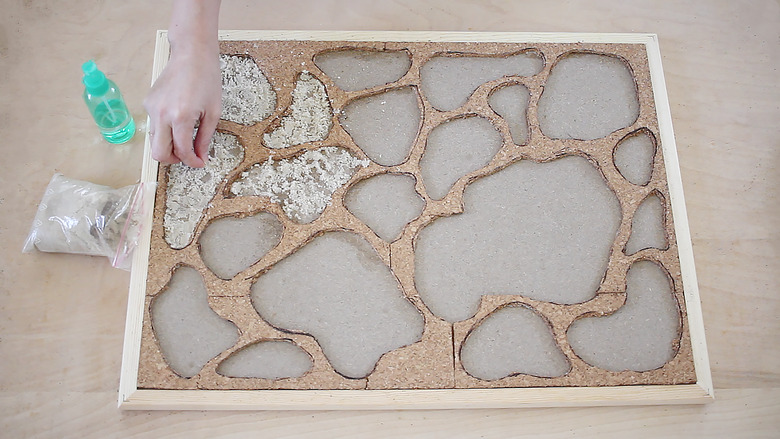 Adding moss adhesive to holes in bulletin board