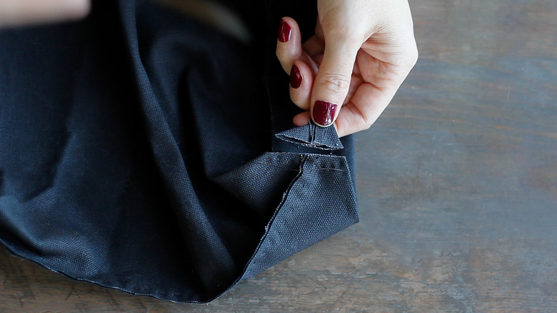 Cutting off excess fabric from corner