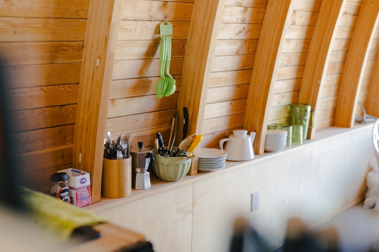 dishware on an open shelf in the kitchen area