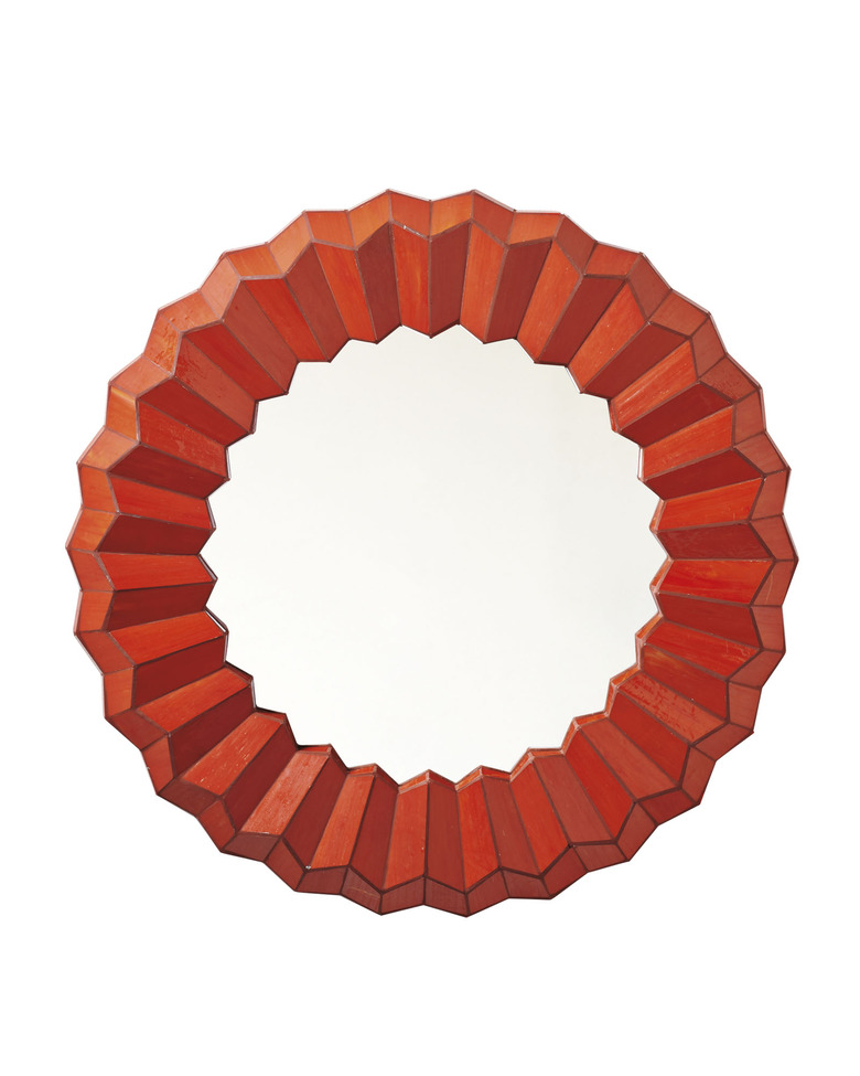 Circular wall mirror with thick orange-red wavy border