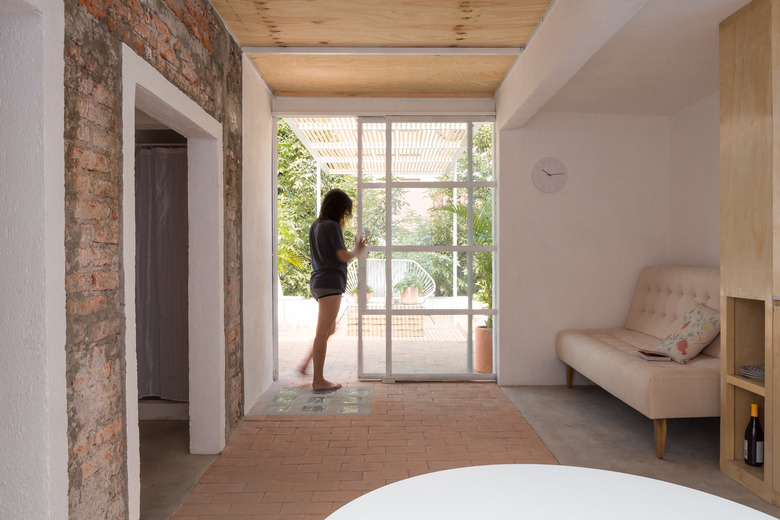 Living room area with sofa and sliding doors.
