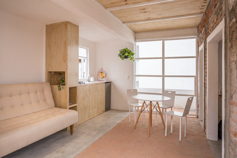 Kitchenette area with sofa and dining room set.