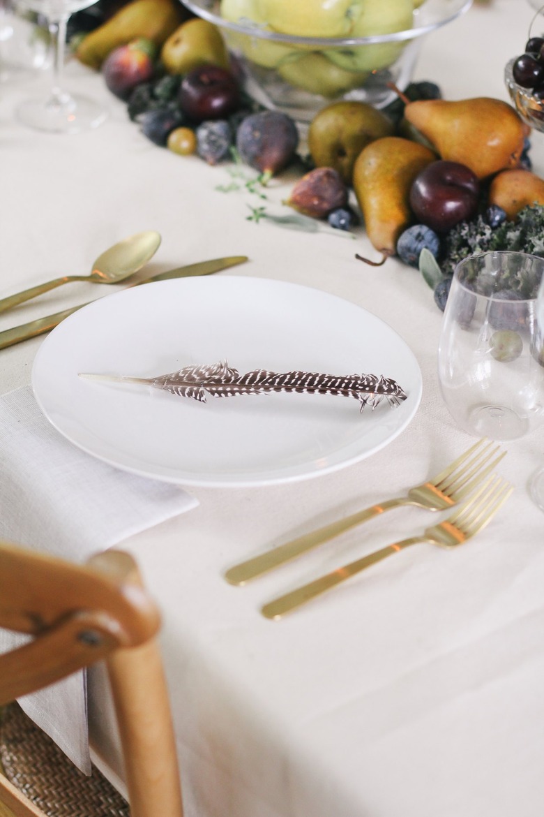 a table with a runner made of fruits and vegetables