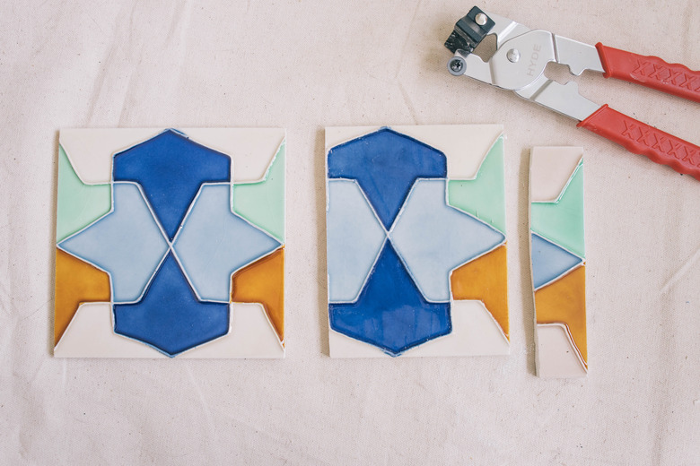 A whole tile and a cut tile with a tile cutter