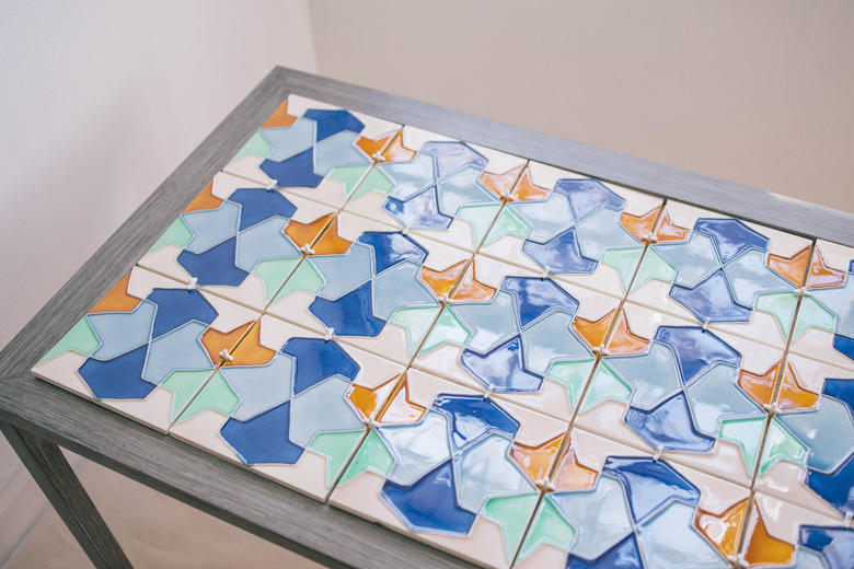 Tiles laid out on top of plywood insert with spacers in between